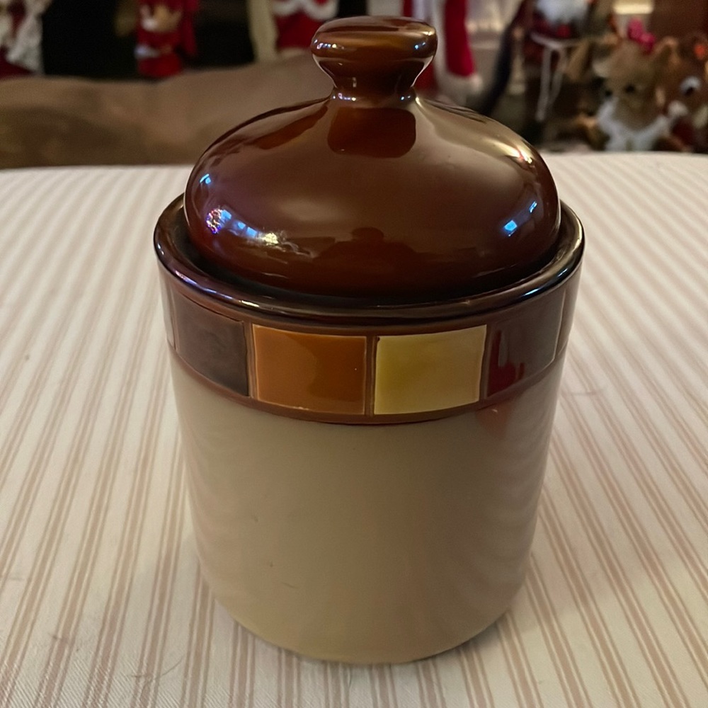 The Casa Estebana Canister is made of stoneware with reactive glazes.